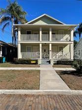 A two-story house with a front porch and balcony stands behind a brick street — 429 RUTH LN UNIT 4, ORLANDO, FL