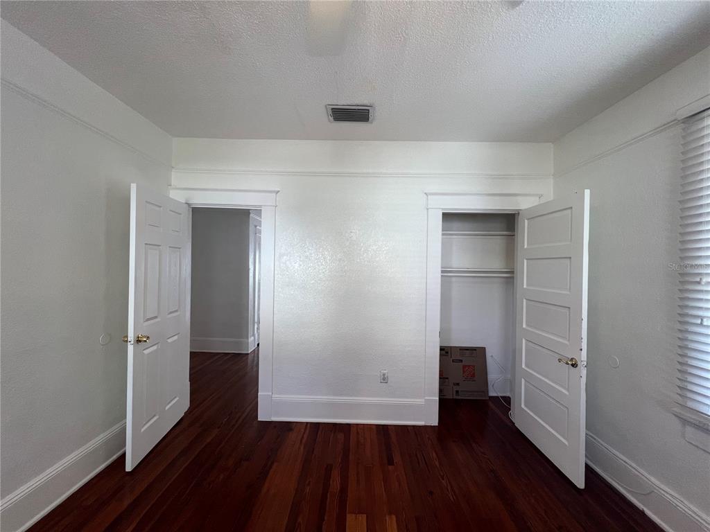 An interior room features hardwood floors, white walls, two doorways, and a built-in closet — 429 RUTH LN UNIT 4, ORLANDO, FL