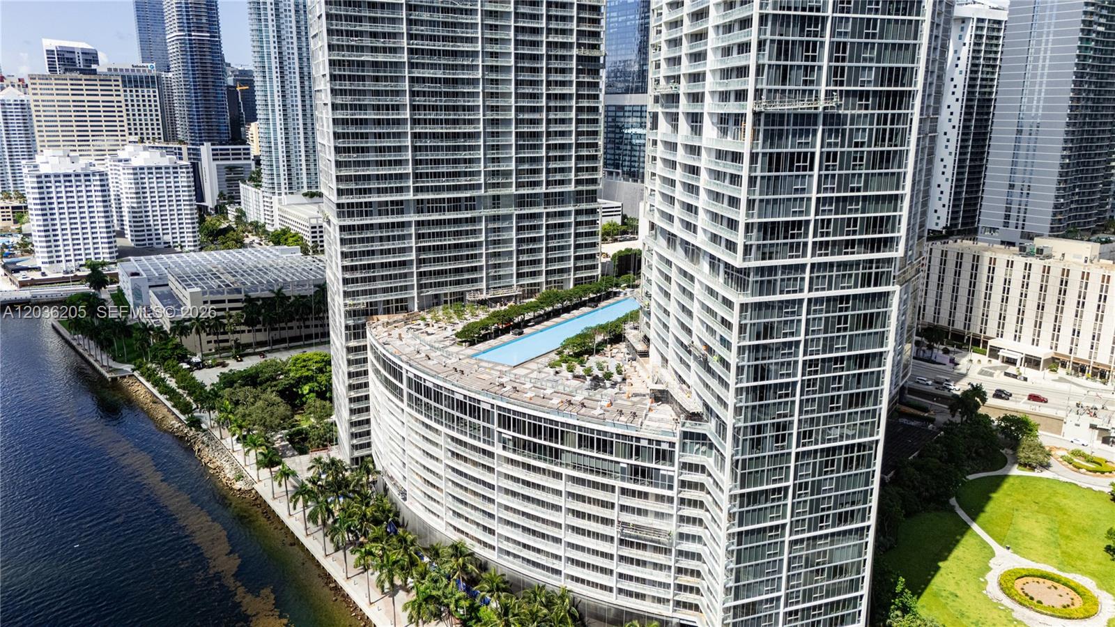 An aerial view shows high-rise apartment buildings with a large swimming pool on a terrace — 465 Brickell Ave # 2101, Miami FL 33131, MIAMI, FL