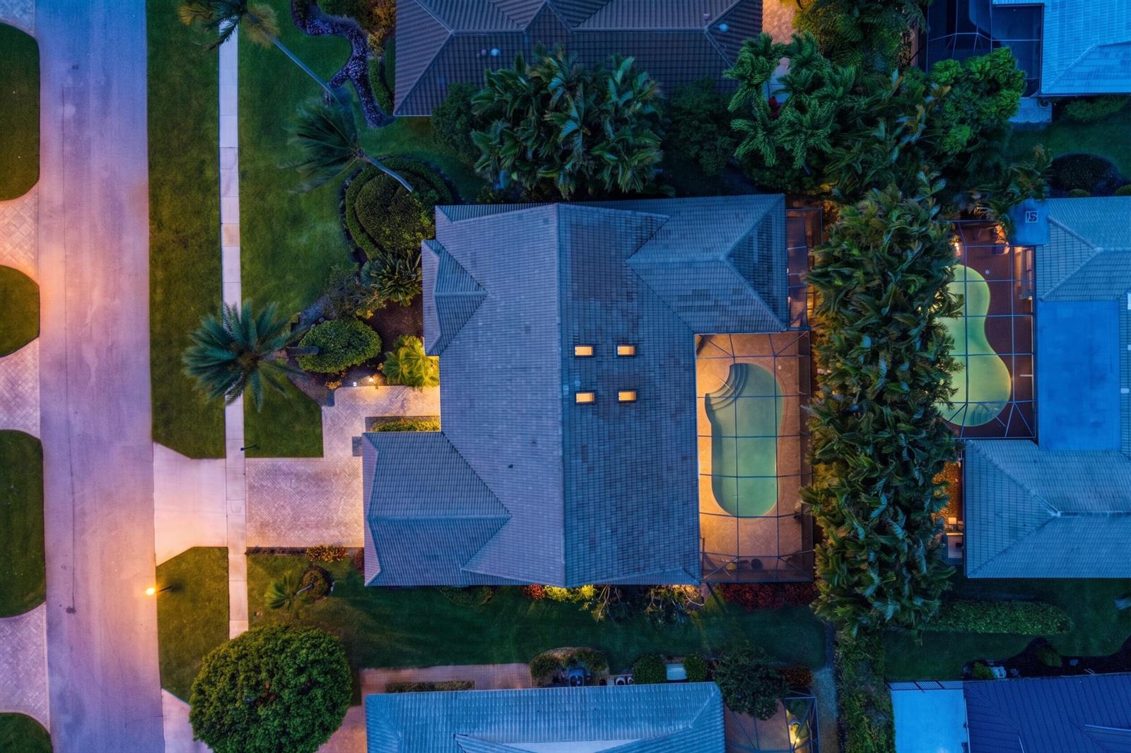 An aerial view shows a house with a tiled roof, a screened-in pool, and landscaping — 4382 White Cedar Lane, Delray Beach FL 33445, DELRAY BEACH, FL