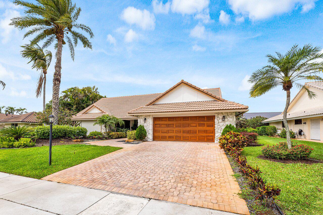 A single-story house with a tiled roof, stone facade, and a paved driveway — 4382 White Cedar Lane, Delray Beach FL 33445, DELRAY BEACH, FL