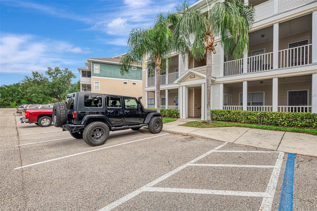 A black Jeep is parked in a lot in front of a multi-story apartment building — 4802 51ST STREET W UNIT 1903, BRADENTON, FL
