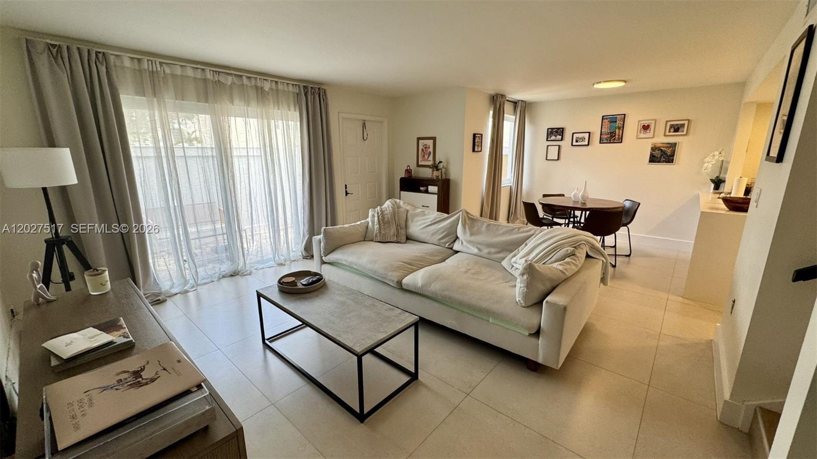 A living room features light tile floors, a beige sofa, and a dining area — 4540 SW 68th Ct Cir # 7, Miami FL 33155, MIAMI, FL