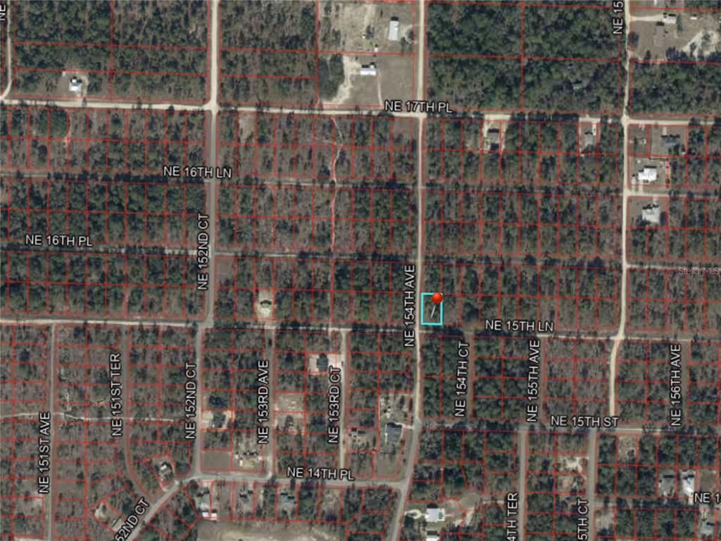 This is an aerial map showing a highlighted plot of land along a residential road — NE 15TH LN LOT 11, WILLISTON, FL