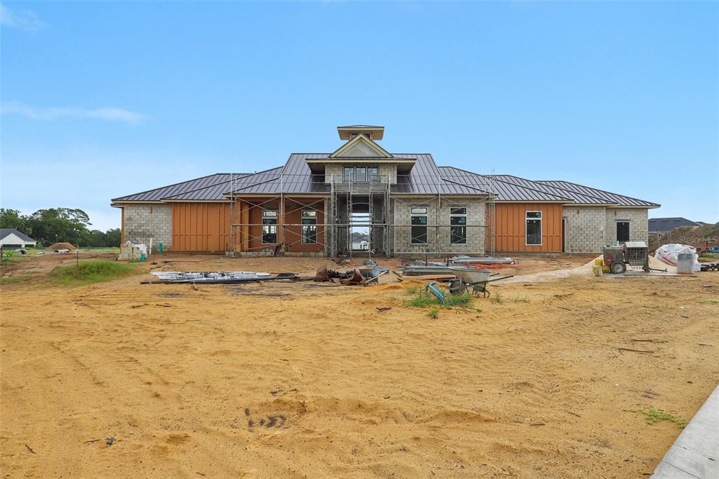 A large, single-story residential building under construction with a metal roof and unfinished exterior walls — 160 CORONADO ROAD, FLAGLER BEACH, FL