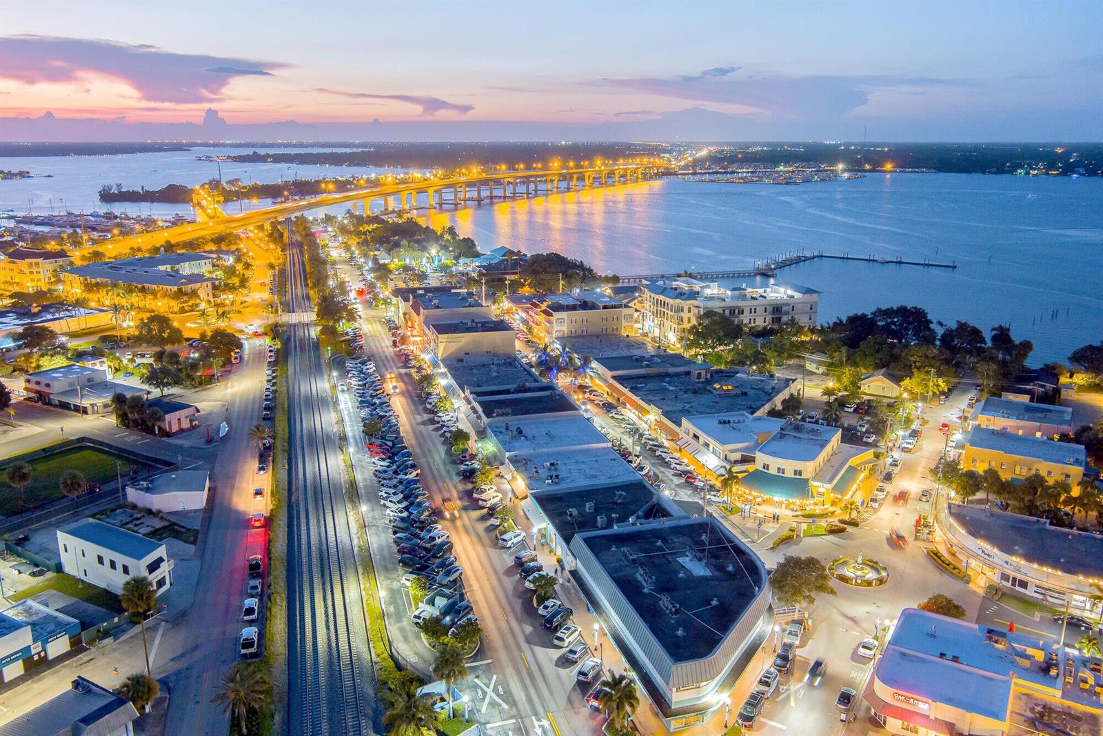 An aerial view shows a coastal town street at dusk with a bridge in the background — 41 SW Seminole Street # 305, Stuart FL 34994, STUART, FL