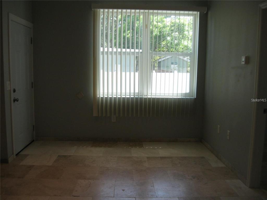 A room with light-colored tile flooring, gray walls, and a large window with vertical blinds — 2009 COCOANUT AVENUE UNIT 2, SARASOTA, FL