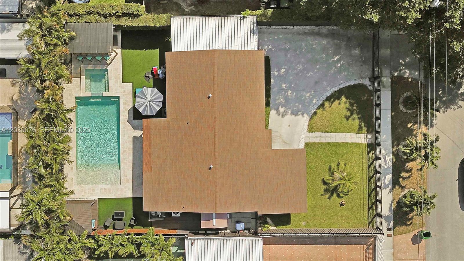 An aerial view shows a house with a brown roof, a pool, and a lawn — 6751 SW 13th St, Miami FL 33144, MIAMI, FL