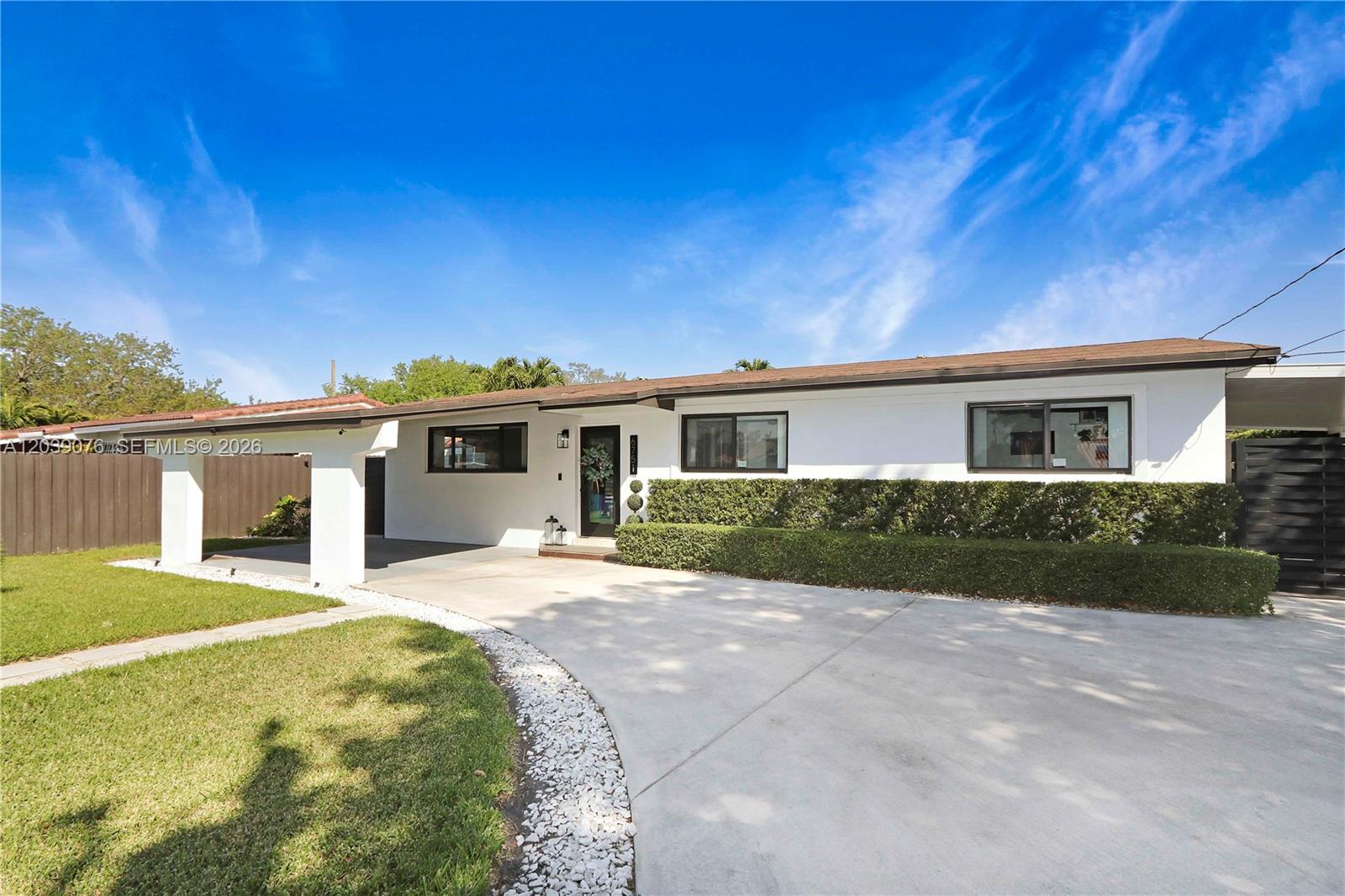 A white single-story house features a concrete driveway, a carport, and a manicured hedge — 6751 SW 13th St, Miami FL 33144, MIAMI, FL