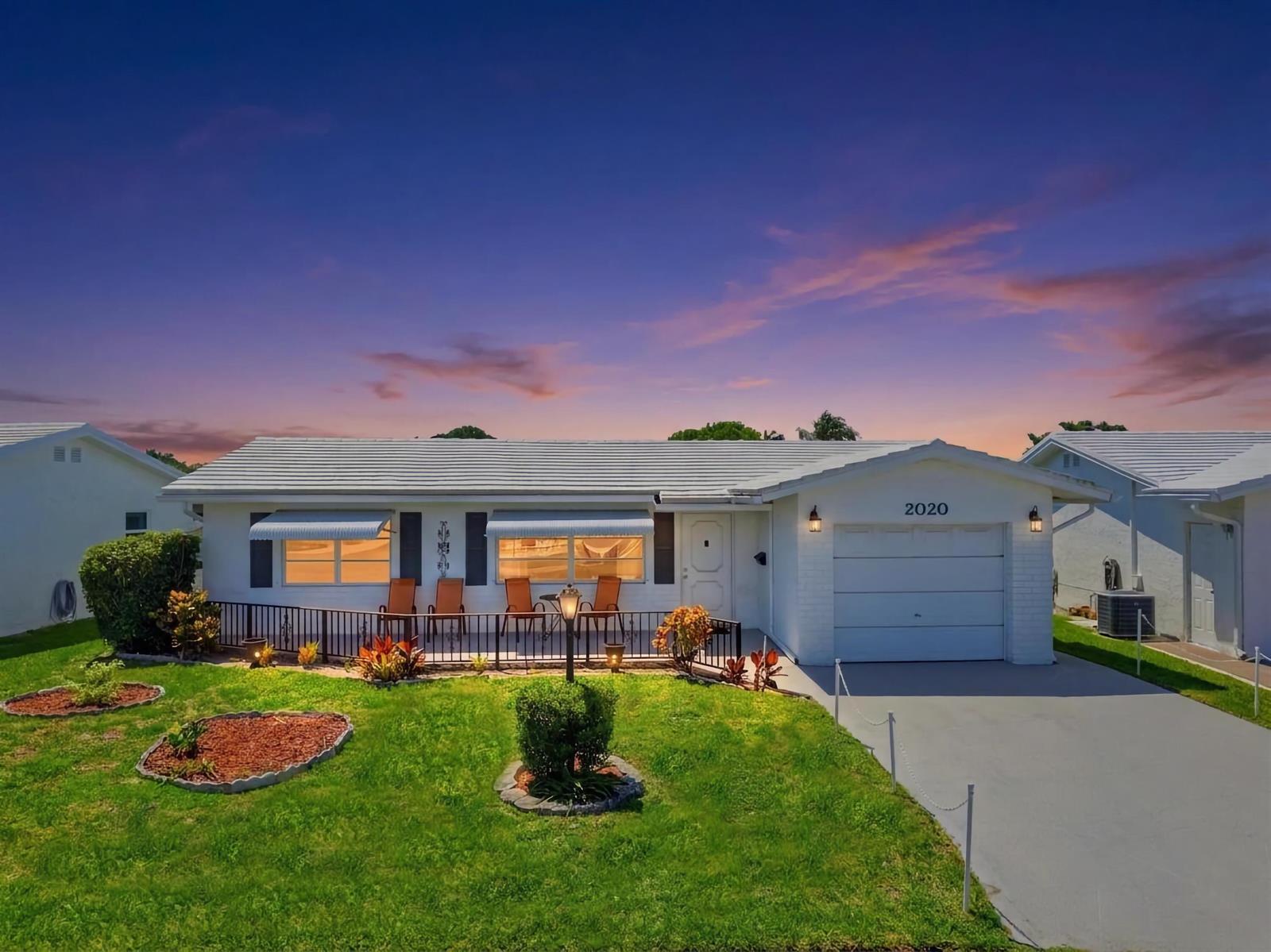 A single-story white house with a garage, a front porch, and a landscaped lawn — 2020 SW 17th Avenue, Boynton Beach FL 33426, BOYNTON BEACH, FL
