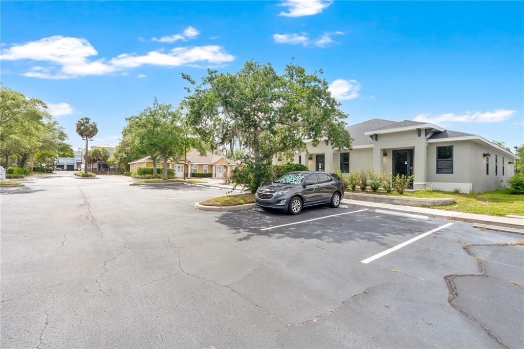 A gray SUV is parked in a paved lot in front of a commercial building — 1300 LEXINGTON GREEN LANE, SANFORD, FL
