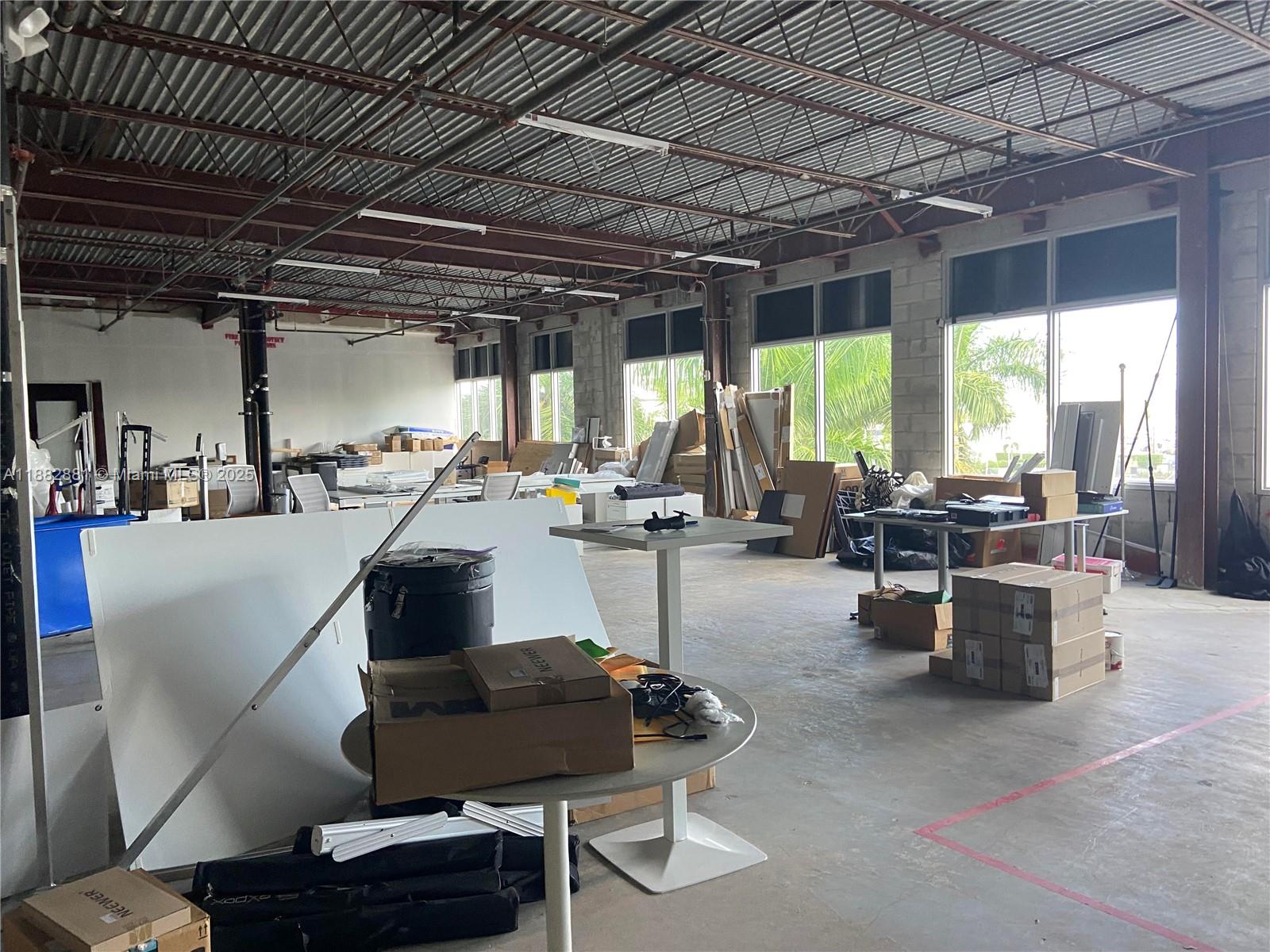 An unfinished industrial office space features exposed ceilings, concrete floors, and large windows — 7950 NW 53rd St # 308, Doral FL 33166, DORAL, FL