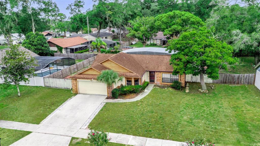 An aerial view of a single-story house with a brown roof, garage, and large yard — 5428 LIGHTHOUSE ROAD, ORLANDO, FL