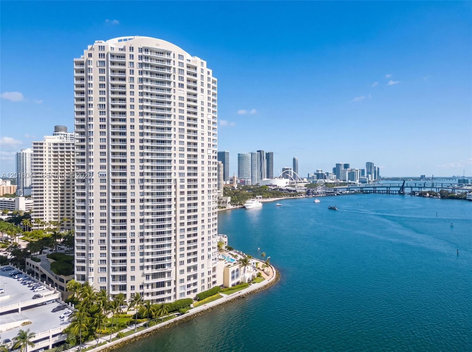 An aerial view shows a tall residential building on a waterfront point near a city — 808 Brickell Key Dr # 3304, Miami FL 33131, MIAMI, FL