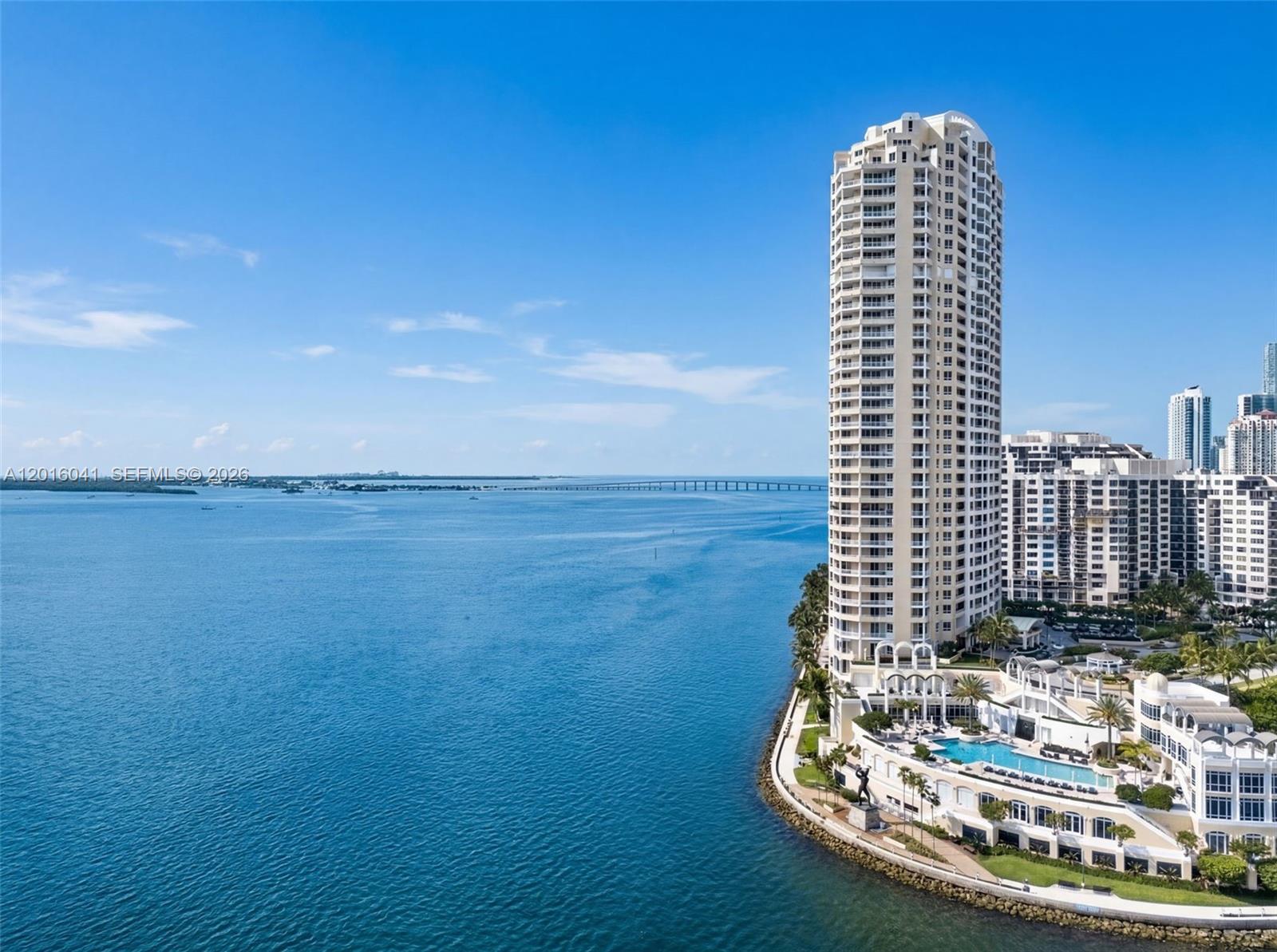 An aerial view shows a tall residential tower on a waterfront with a swimming pool — 808 Brickell Key Dr # 3304, Miami FL 33131, MIAMI, FL