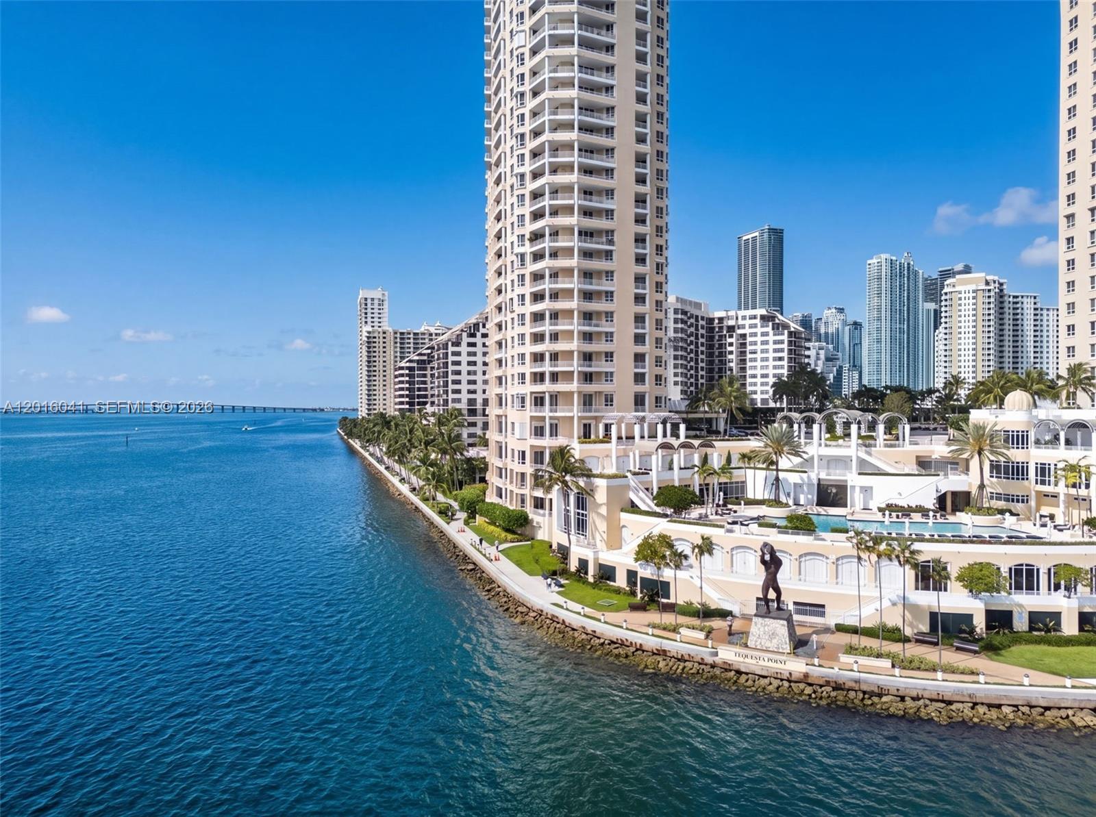 An aerial view of a waterfront high-rise residential building with a pool and statue — 808 Brickell Key Dr # 3304, Miami FL 33131, MIAMI, FL