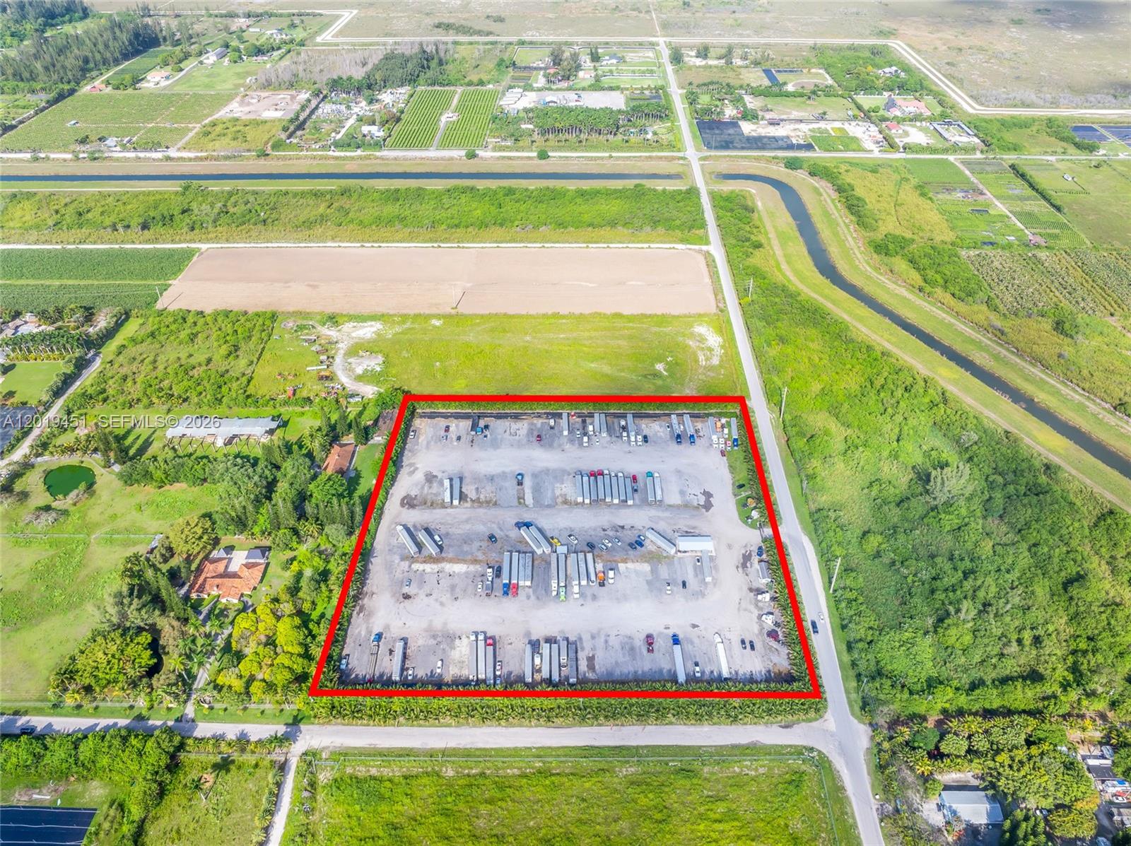 An aerial view shows a rectangular lot used for truck parking, outlined in red — SW 136TH ST, Unincorporated Dade County FL 33196, UNINCORPORATED DADE COUNTY, FL