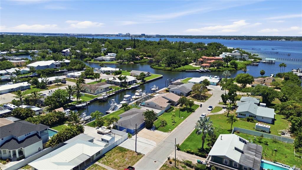 An aerial view shows waterfront homes with private docks along a canal in Florida — 908 24TH AVENUE W, PALMETTO, FL
