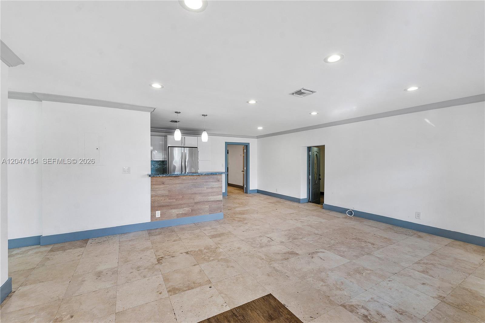 An open-concept living area features tile flooring, recessed lighting, and a kitchen breakfast bar — 1541 SW 52nd Ave, Plantation FL 33317, PLANTATION, FL