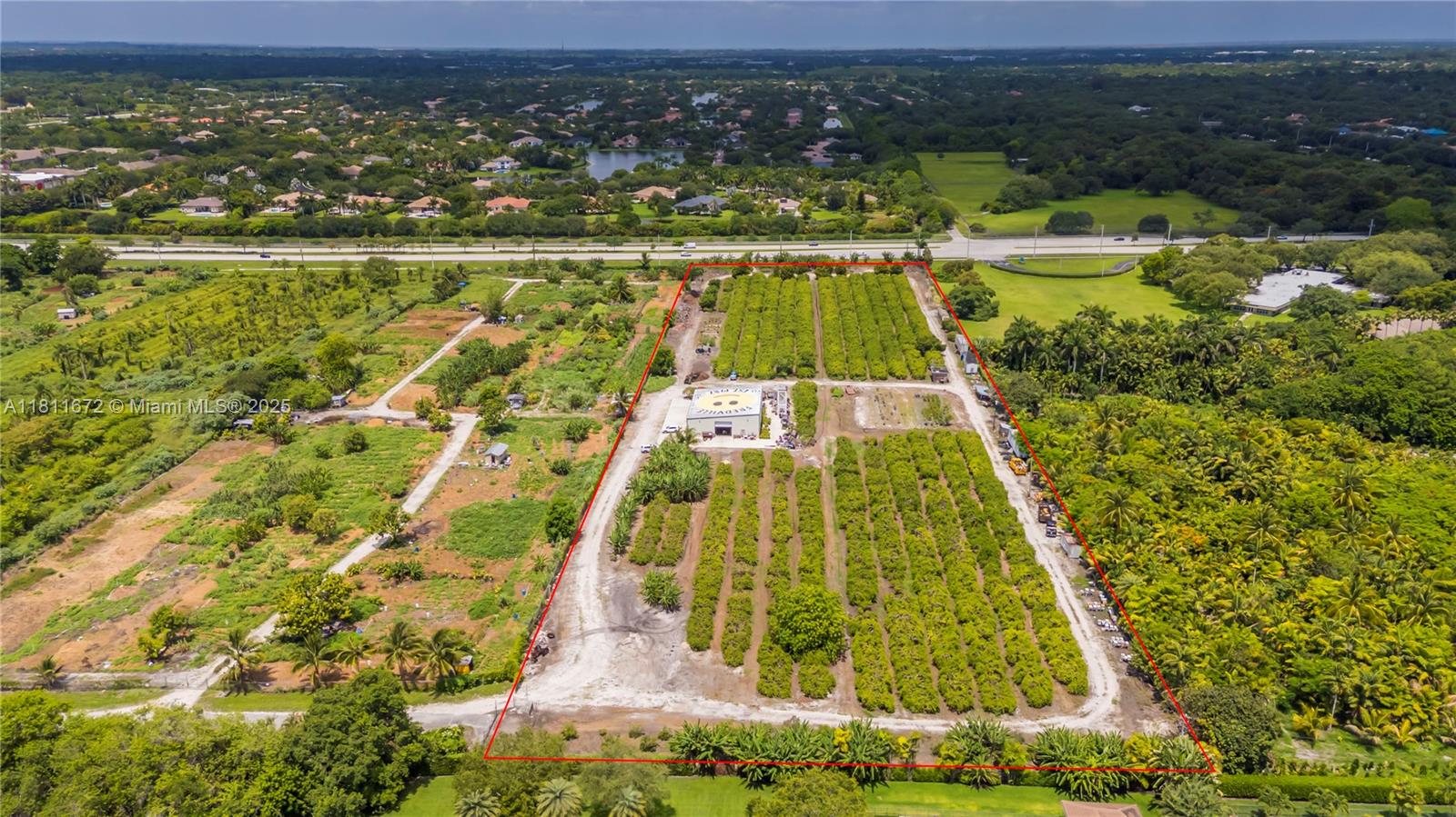 An aerial view shows a rectangular agricultural property with rows of trees and a building — 4077 SW 121st Ter, Davie FL 33330, DAVIE, FL