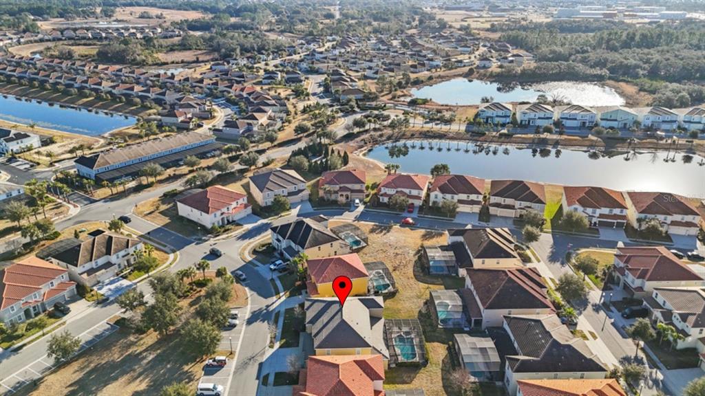 An aerial view shows a suburban neighborhood with houses, a lake, and a red location pin — 6009 BROAD OAK DRIVE, DAVENPORT, FL