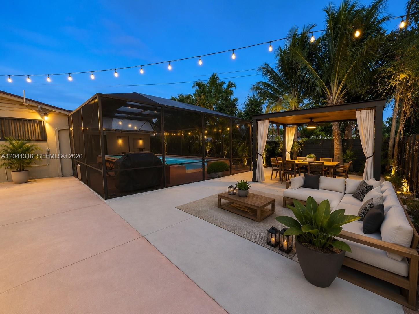 A backyard patio features a screened pool enclosure, a covered dining area, and outdoor seating — 10015 SW 213th Ter, Cutler Bay FL 33189, CUTLER BAY, FL