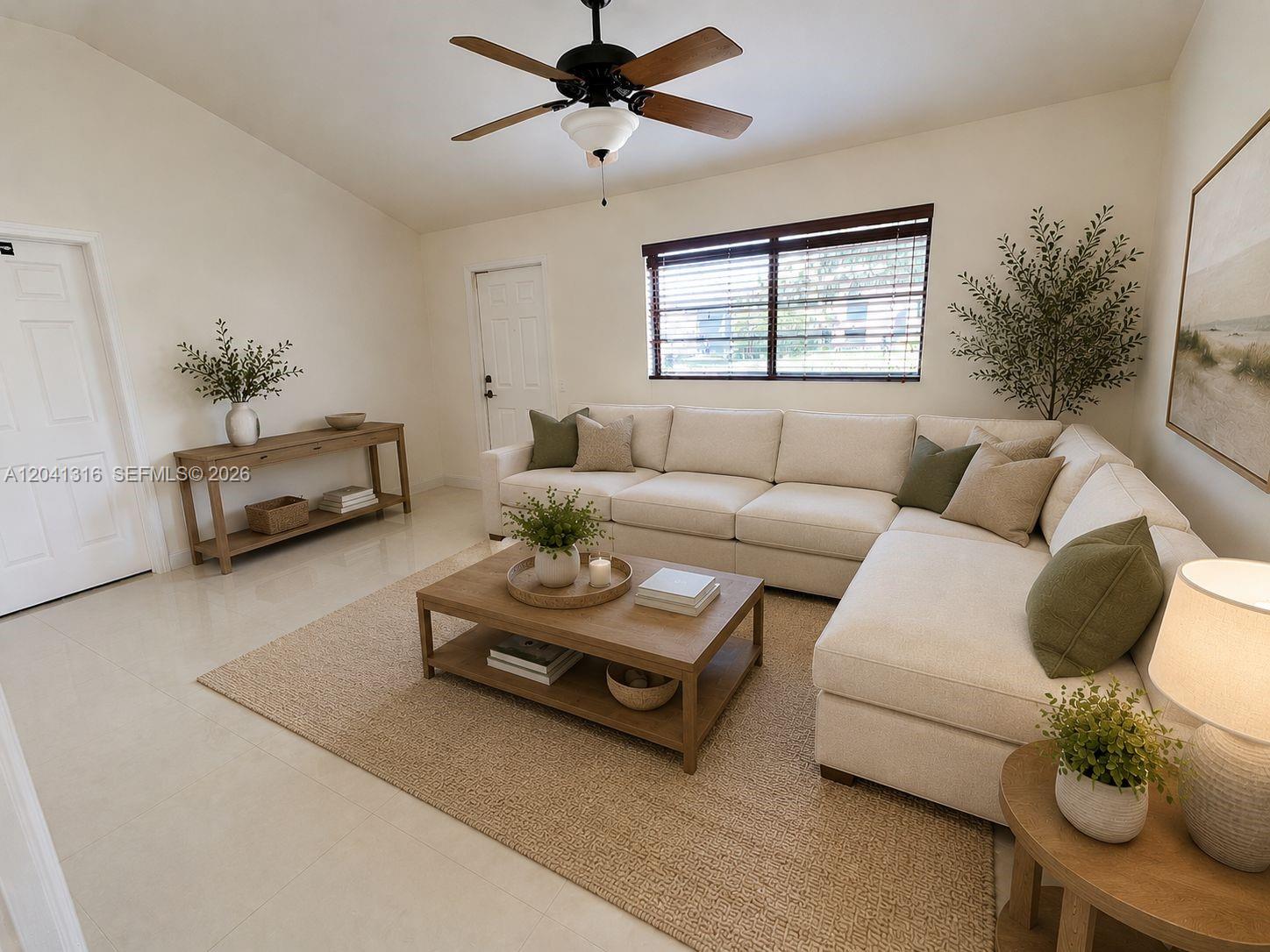 A living room features a large sectional sofa, a wooden coffee table, and a ceiling fan — 10015 SW 213th Ter, Cutler Bay FL 33189, CUTLER BAY, FL