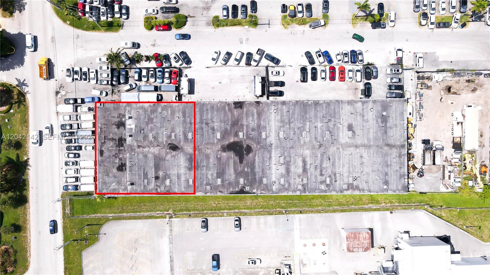An aerial view shows a large commercial warehouse building with a red-outlined roof section — 5500 NW 74th Ave, Miami FL 33166, MIAMI, FL