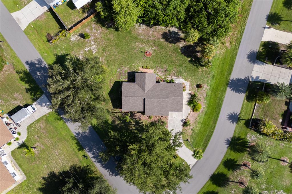 An aerial view shows a house with a shingled roof surrounded by trees and lawns — 6232 ROBERTA DRIVE, ENGLEWOOD, FL