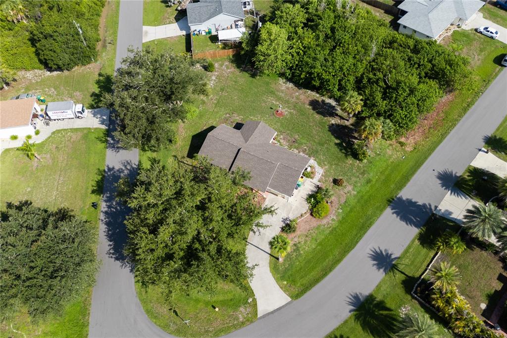An aerial view shows a single-story house with a shingled roof surrounded by trees — 6232 ROBERTA DRIVE, ENGLEWOOD, FL