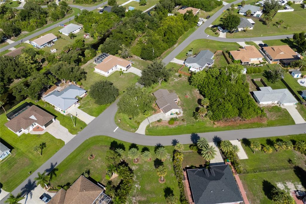 An aerial view shows several single-family homes surrounded by trees and paved roads — 6232 ROBERTA DRIVE, ENGLEWOOD, FL