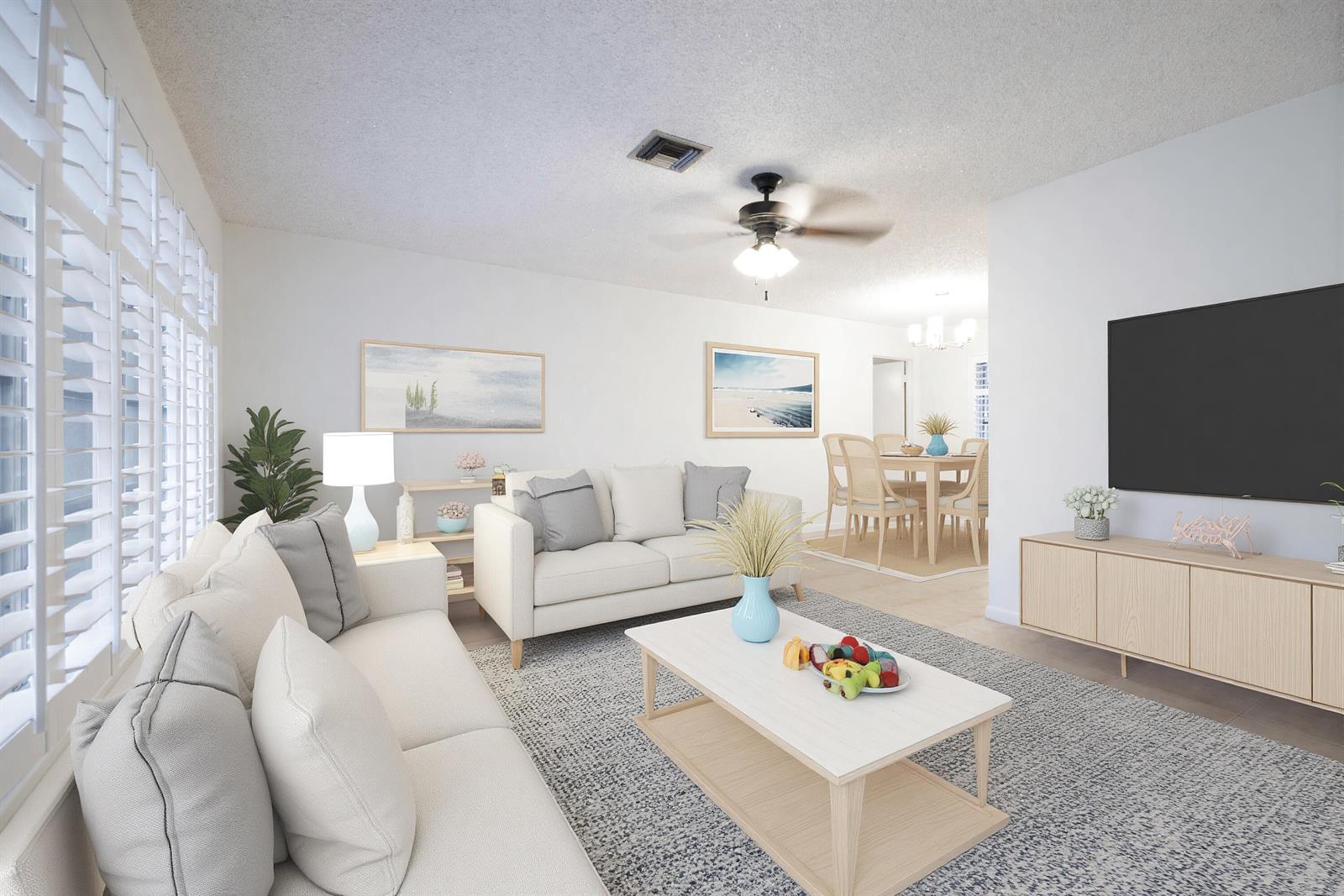 This living room features light-colored sofas, a coffee table, a television, and a dining area — 18020 Palm Point Drive, Jupiter FL 33458, JUPITER, FL