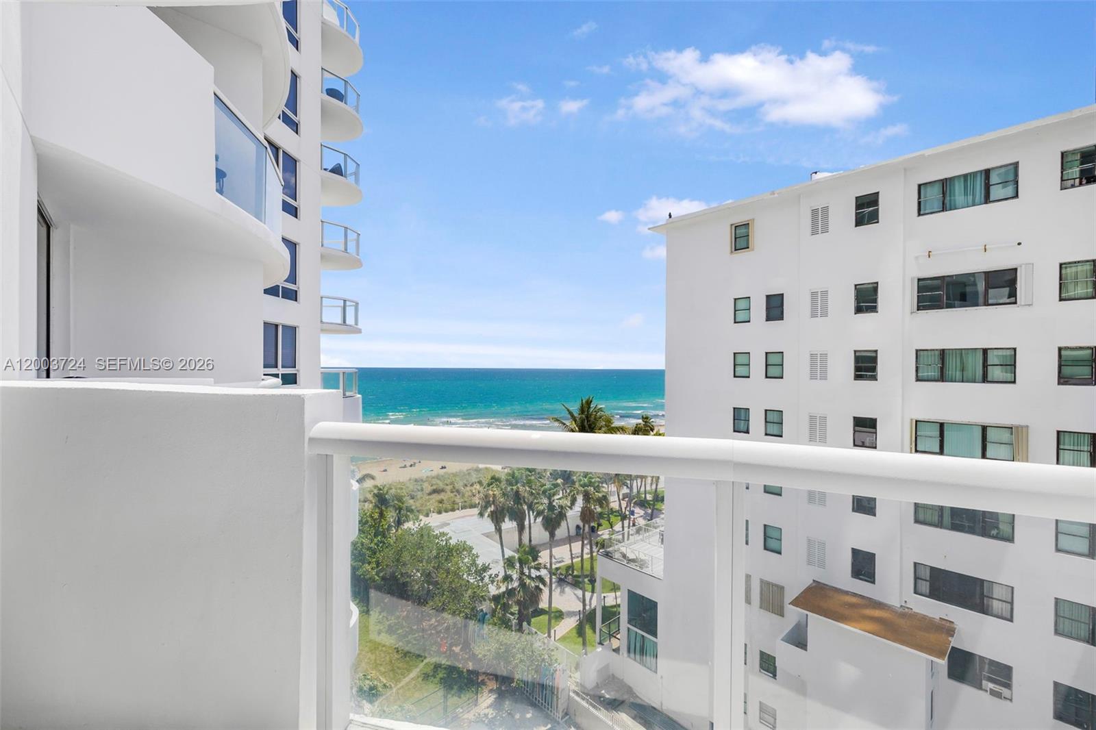 A modern kitchen features white cabinets, stainless steel appliances, and a dark tiled backsplash — 6365 Collins Ave # 805, Miami Beach FL 33141, MIAMI BEACH, FL