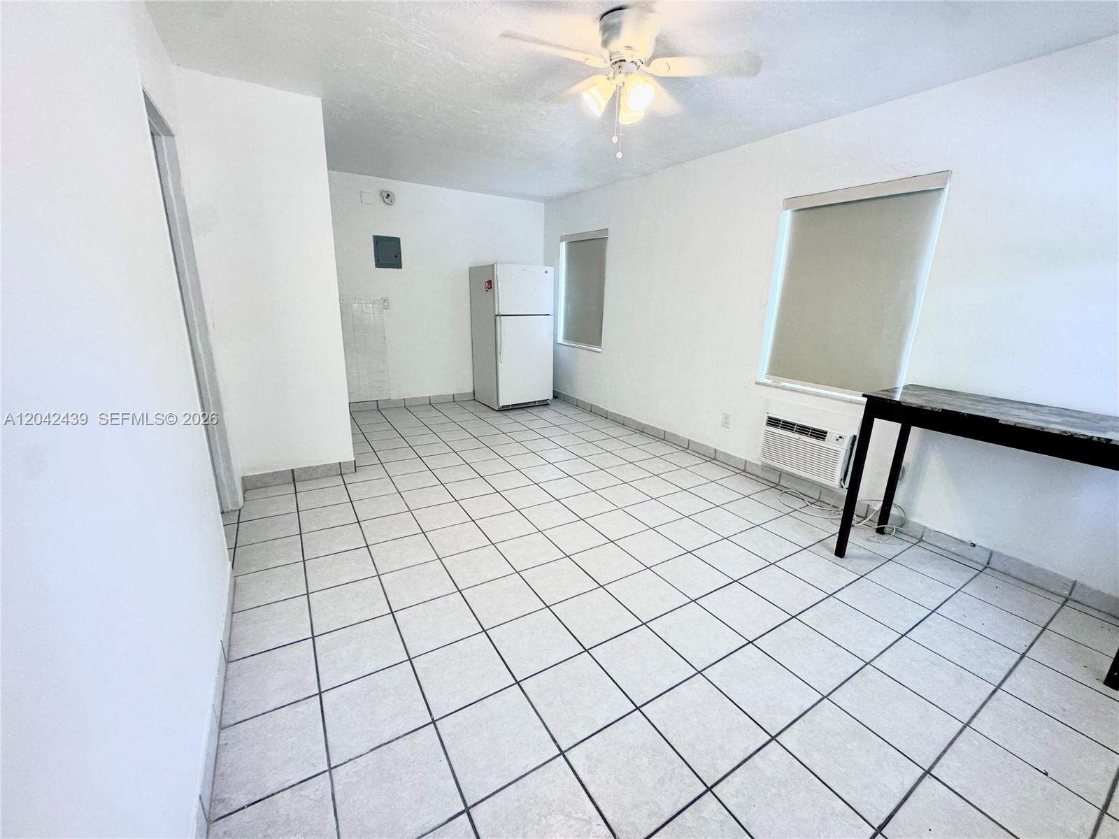 This room features white walls, a tiled floor, a refrigerator, and a ceiling fan — 2732 SW 22nd STREET # 3, Miami FL 33133, MIAMI, FL