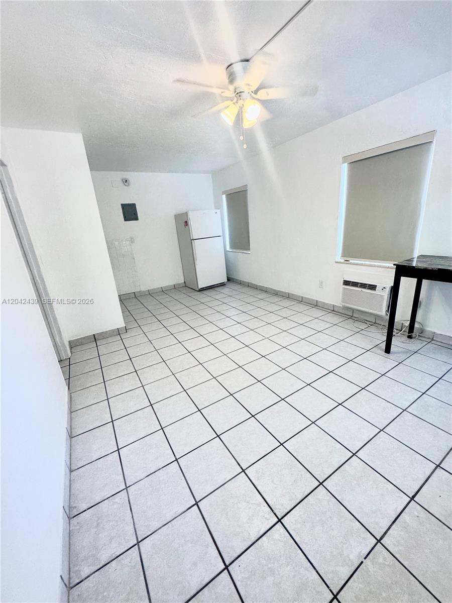 A room with white walls, tiled floors, a ceiling fan, and a white refrigerator — 2732 SW 22nd STREET # 3, Miami FL 33133, MIAMI, FL