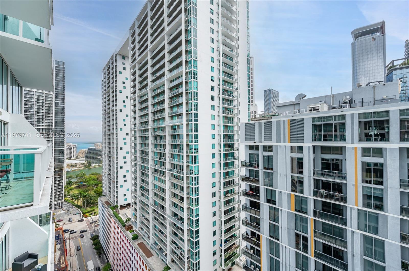 An elevated exterior view shows several modern high-rise apartment buildings in a dense urban area — 41 SE 5th St # 1508, Miami FL 33131, MIAMI, FL