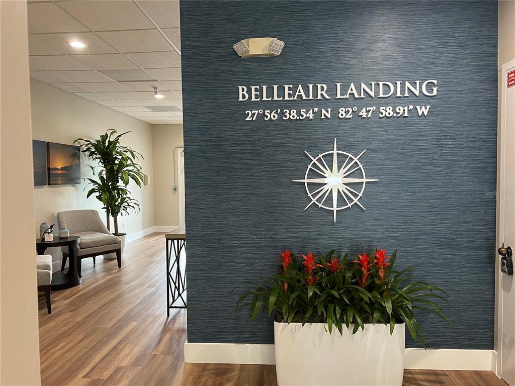 A lobby area features a blue accent wall with signage, a compass rose, and plants — 1465 S FORT HARRISON AVENUE, CLEARWATER, FL