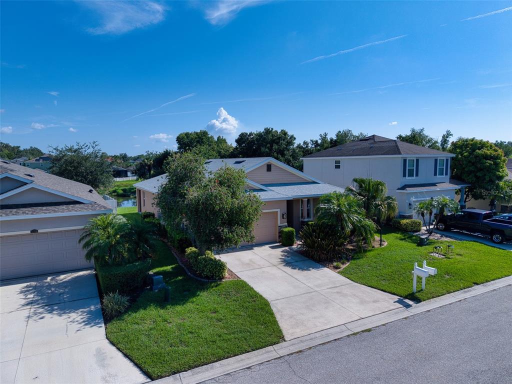 An aerial view of a suburban single-story house with a driveway and green lawn — 5710 BROAD RIVER RUN, ELLENTON, FL