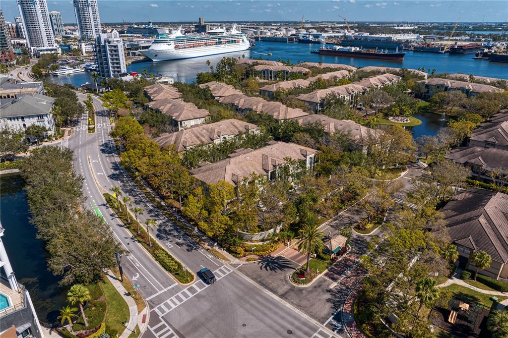 An aerial view shows a residential complex with brown roofs near a harbor and cruise ship — 751 CORAL REEF DRIVE, TAMPA, FL