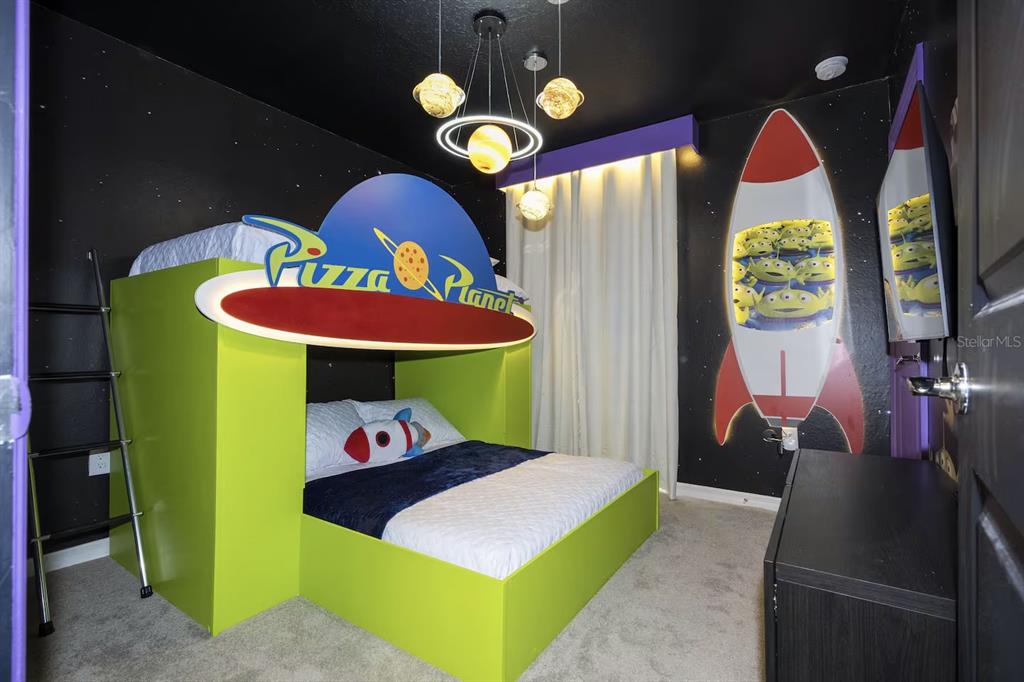 A themed bedroom features a Pizza Planet bunk bed, space-themed decor, and a rocket wall mural — 4294 LANA AVENUE, DAVENPORT, FL