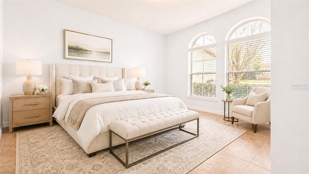A bright bedroom features a tufted bed, a bench, two nightstands, and arched windows — 8531 GEDDES LOOP, ORLANDO, FL