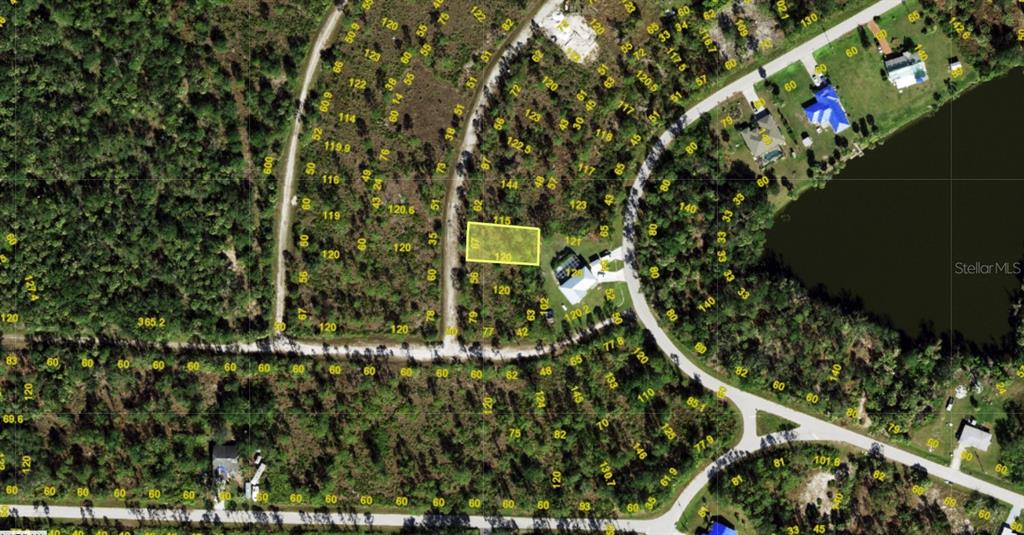 This is an aerial map showing a highlighted rectangular residential lot in a wooded area — 12088 VENETIAN STREET, PORT CHARLOTTE, FL