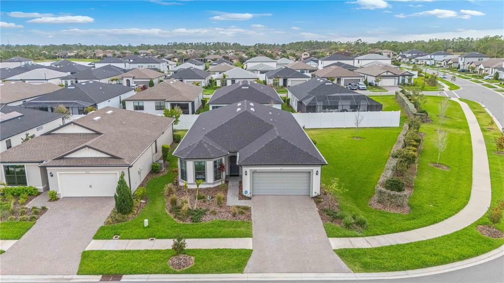 An aerial view shows a suburban house with a gray roof and a paved driveway — 2414 GABEL OAK DRIVE, NORTH PORT, FL
