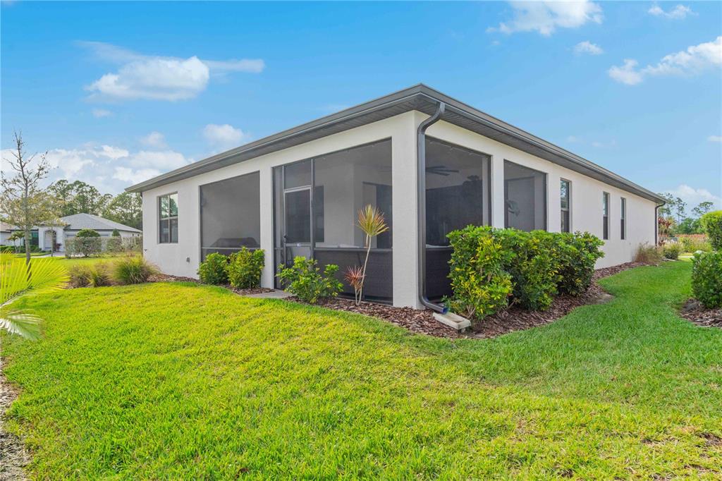A single-story house with a screened-in back porch and a grassy yard — 2414 GABEL OAK DRIVE, NORTH PORT, FL