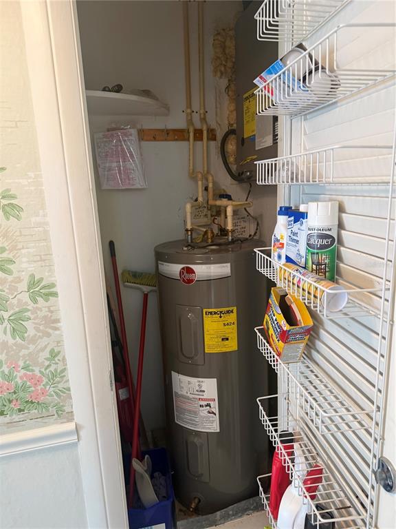 A water heater and cleaning supplies are stored inside a small utility closet — 775 JOHN RINGLING BOULEVARD UNIT # 33, SARASOTA, FL