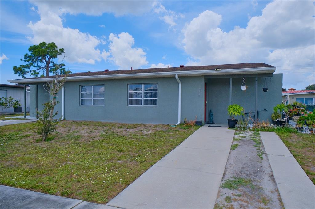 A single-story gray house with a concrete walkway and a small front lawn — 6231 CONISTON TERRACE, NORTH PORT, FL