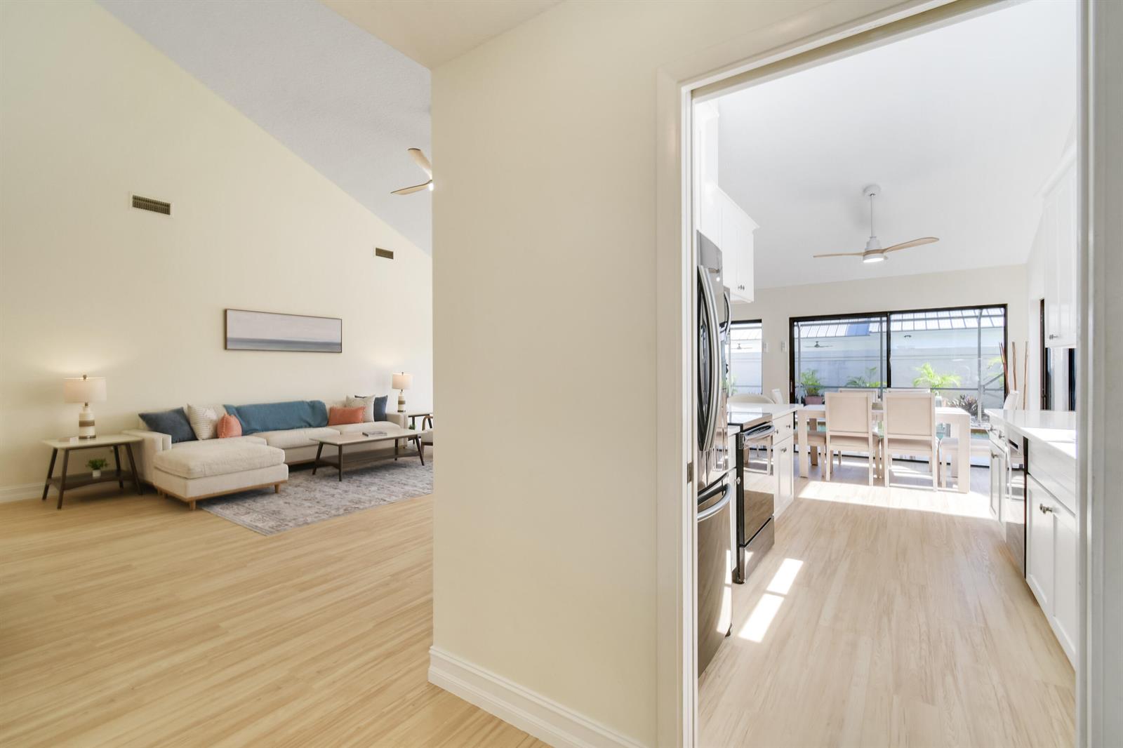 A view from a doorway looking into a living room and an adjacent kitchen area — 137 Harbourside Circle, Jupiter FL 33477, JUPITER, FL
