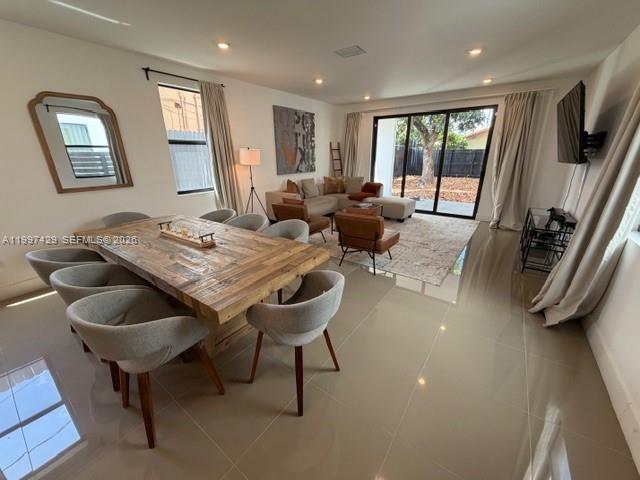 A dining area with a wooden table and chairs opens into a living room space — 3645 SW 3 st, Miami FL 33135, MIAMI, FL