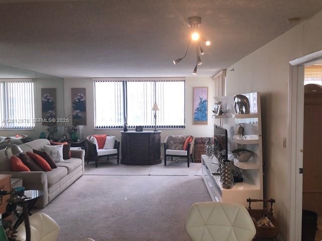 A living room features a beige sofa, two accent chairs, and a modern light fixture — 540 Brickell Key Dr # 1116, Miami FL 33131, MIAMI, FL