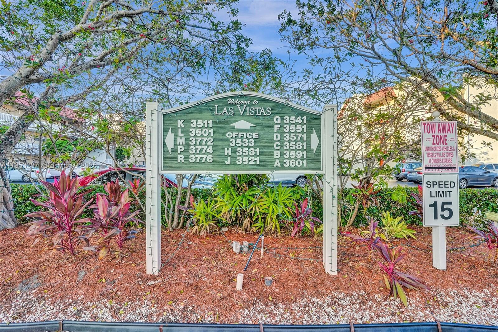 A directory sign for Las Vistas stands in a landscaped area with a speed limit sign — 3511 E Inverrary Dr # 107, Lauderhill FL 33319, LAUDERHILL, FL
